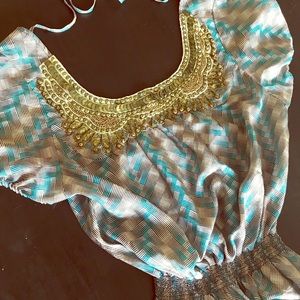 100% silk dress with gold accessory on neckline